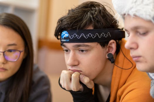 Home Teenagers engaged in a study session using a neurotech headband for focus and concentration.