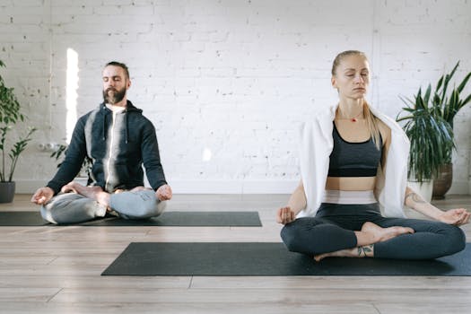 Home Couple meditating in lotus position in a serene room, enhancing mental peace.
